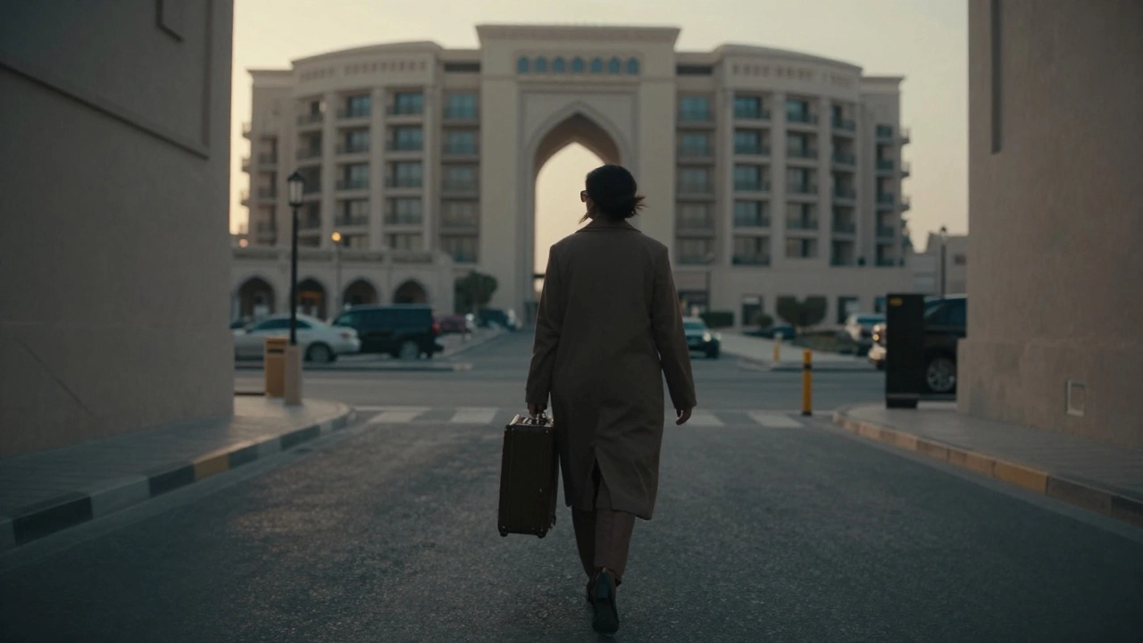 A woman walks swiftly through a quiet Dubai alley at dawn, suitcase in hand, hidden from view.